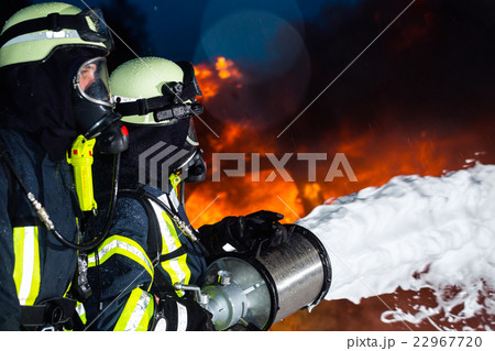 Firefighter - Firemen extinguishing a large blaze 22967720