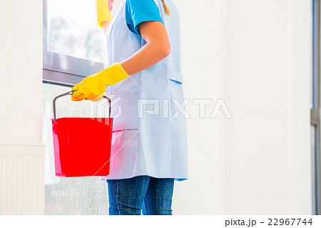 Cleaning lady with cloth at window 22967744