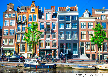 Traditional dutch buildings on canal in Amsterdam Traditional dutch buildings on canal in Amsterdam 22968340