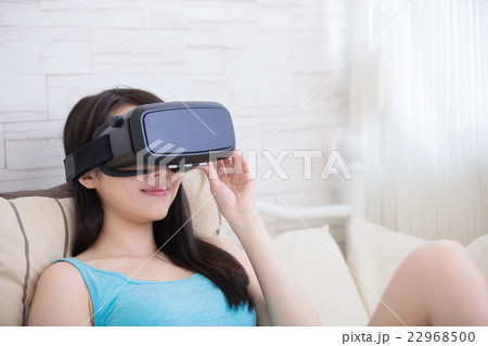 woman using VR headset glasses 22968500