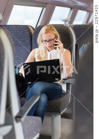 Business woman working while travelling by train. 22971435