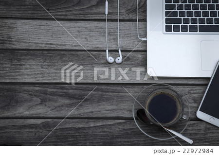Coffee cup smart phone and laptop on wood table Coffee cup smart phone and laptop on wood table 22972984