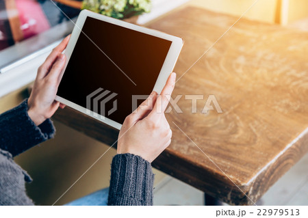 woman play tablet computer in coffee shop  22979513