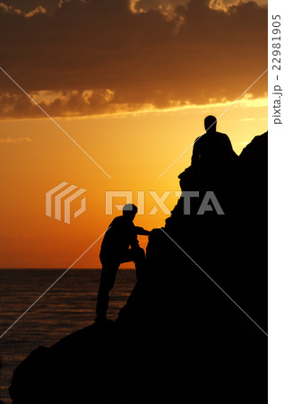 Two silhouette of people in beautiful sunset 22981905