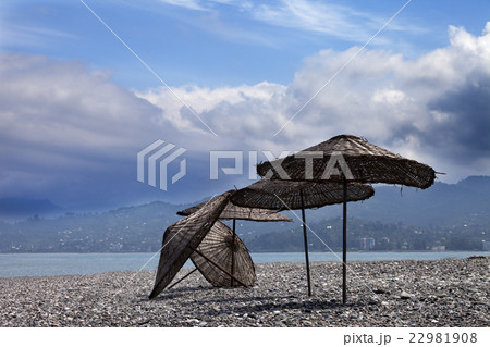 Old sunshade on deserted beach 22981908