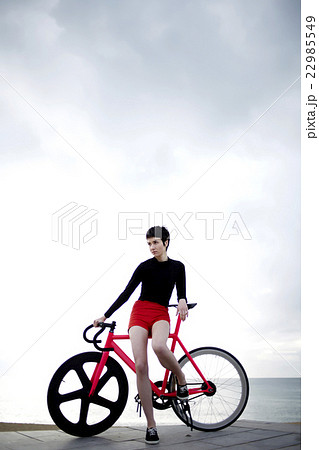 Professional female cyclist enjoying the rest Professional female cyclist enjoying the rest 22985549