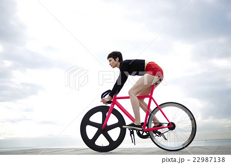 Sporty woman enjoy ride on bicycle in cloudy day Sporty woman enjoy ride on bicycle in cloudy day 22987138