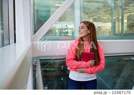 Girl after classes at school resting in hallway Girl after classes at school resting in hallway 22987170