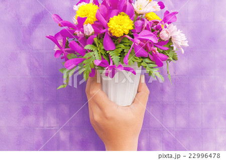 Hand holding bouquet of chrysanthemum flowers Hand holding bouquet of chrysanthemum flowers 22996478