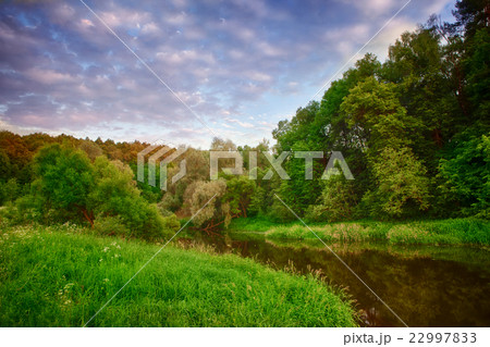 Colorful summer evening on the mountain river. 22997833