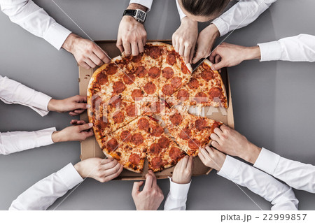 Business team eating pizza Business team eating pizza 22999857