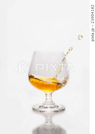 Whiskey splashing into the glass Whiskey splashing into the glass 23004182