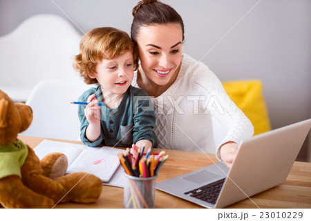 Mother and child looking at laptop Mother and child looking at laptop 23010229