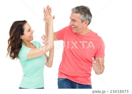 Excited couple giving a high-five 23018073