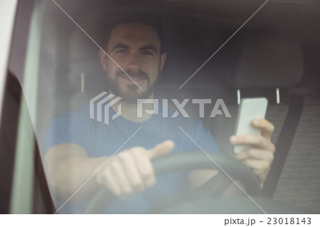 Delivery man driving his van 23018143