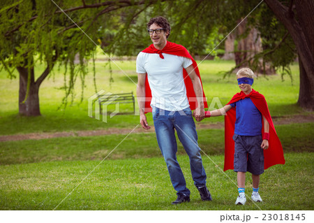 Father and son pretending to be superhero 23018145