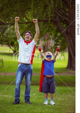 Father and son pretending to be superhero 23018202