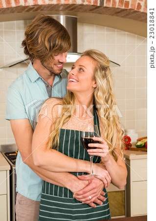 Cute couple hugging and enjoying a glass of wine 23018841