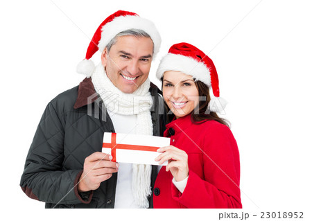 Festive couple holding christmas gift 23018952