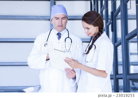 Doctors checking a medical report Doctors checking a medical report 23019255