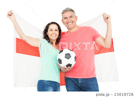 Excited football fan couple cheering at camera Excited football fan couple cheering at camera 23019726