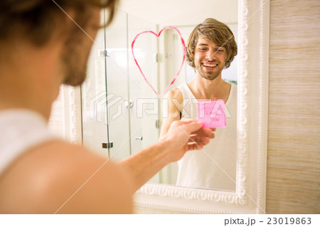 Boyfriend discovering a love message on the mirror Boyfriend discovering a love message on the mirror 23019863