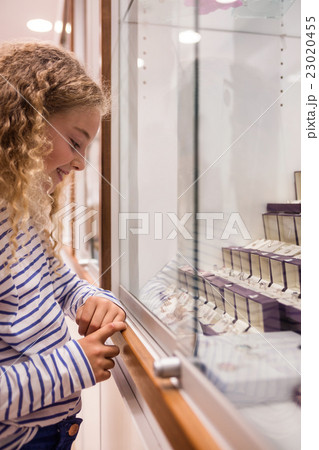 Happy girl looking at jewelry display 23020455