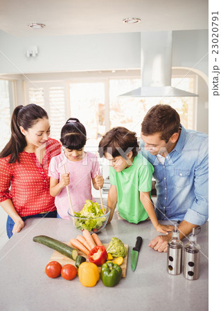 Happy family preparing salad Happy family preparing salad 23020791