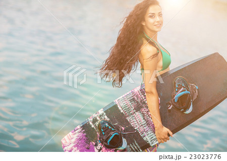 Young attractive woman with wakeboard 23023776