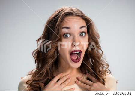 Portrait of young woman with shocked facial Portrait of young woman with shocked facial 23026332