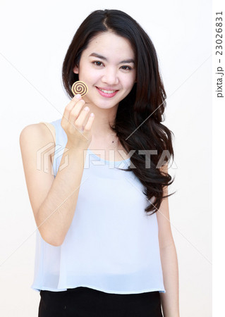 Young pretty lady with cookie isolated on white Young pretty lady with cookie isolated on white 23026831