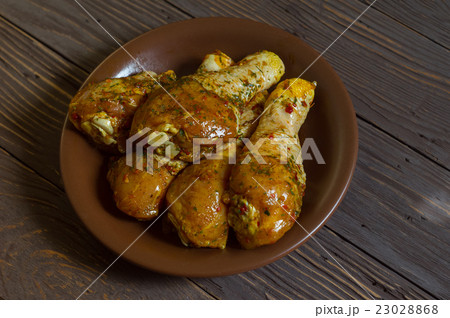 Raw Chicken Legs With Spices Lie On A Platter Raw Chicken Legs With Spices Lie On A Platter 23028868