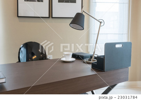 wooden table and books in modern working room wooden table and books in modern working room 23031784