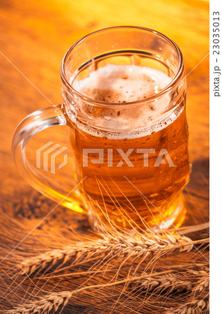 mug beer with ears of wheat on the wooden table mug beer with ears of wheat on the wooden table 23035013