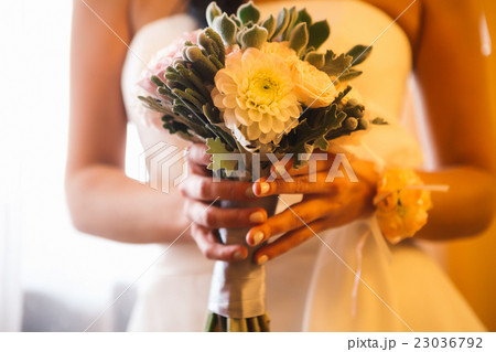Beautiful wedding bouquet flowers in hands bride Beautiful wedding bouquet flowers in hands bride 23036792