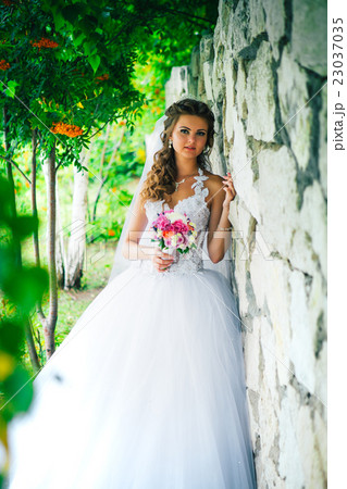 Stylish gorgeous bride standing white background 23037035