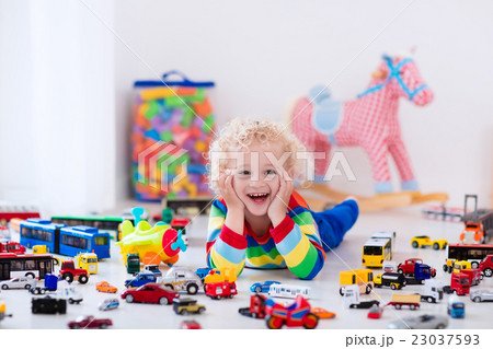 Little boy playing with toy cars 23037593
