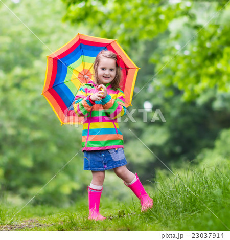 Child playing in the rain Child playing in the rain 23037914