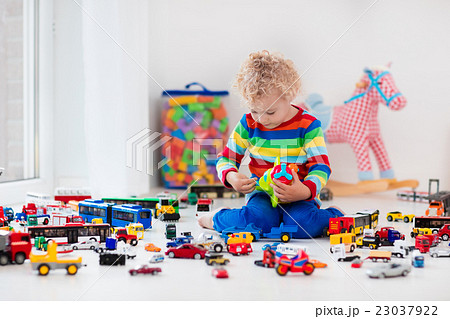 Little boy playing with toy cars Little boy playing with toy cars 23037922