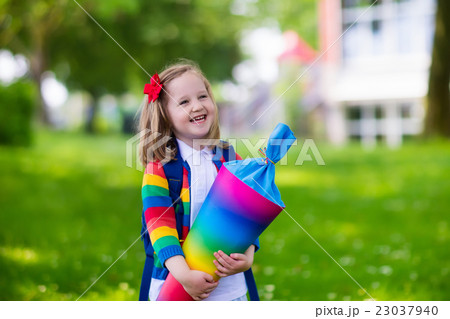 Little child with candy cone on first school day 23037940