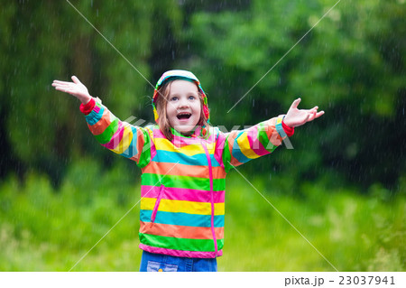 Child playing in the rain 23037941