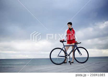 Female with rental bike enjoying weekend stroll 23041065