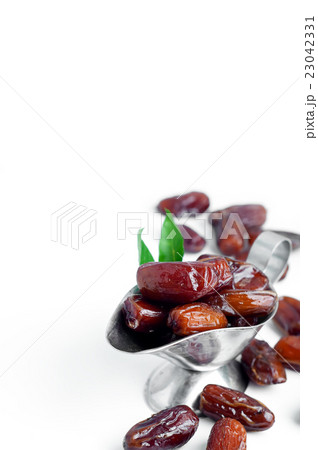 Dates in a bowl on white background. 23042331