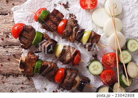 Delicious kebab with vegetables on skewers Delicious kebab with vegetables on skewers 23042808