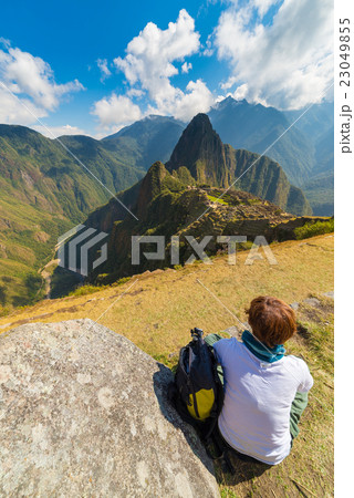 Tourist looking at Machu Picchu from above, Peru 23049855