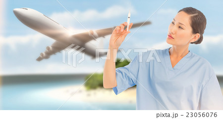 Composite image of serious doctor holding an injection in hospit Composite image of serious doctor holding an injection in hospit 23056076