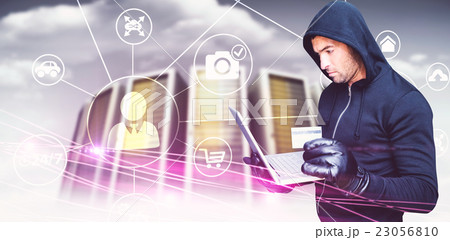 Composite image of hacker holding laptop and credir card 23056810