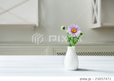 Aster amellus flower bouquet at white table 23057471