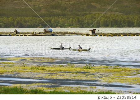 Sunset over Lake Batur. Fishermen in their boats 23058814