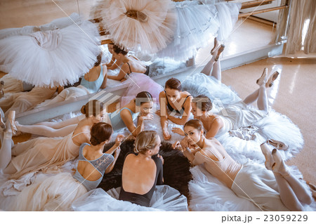 The seven ballerinas against ballet bar 23059229